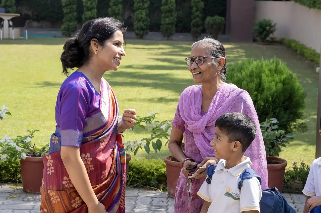 Parents and grandparents talking in the school garden
