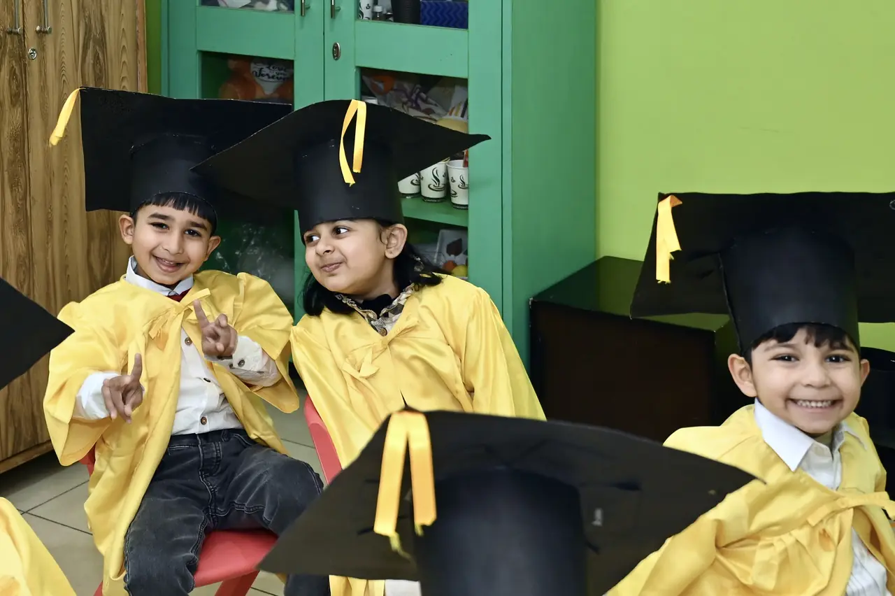 Little graduates in caps and gowns