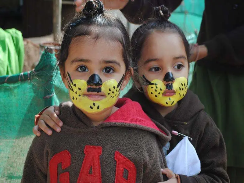 Two children with painted faces on Picnic Day
