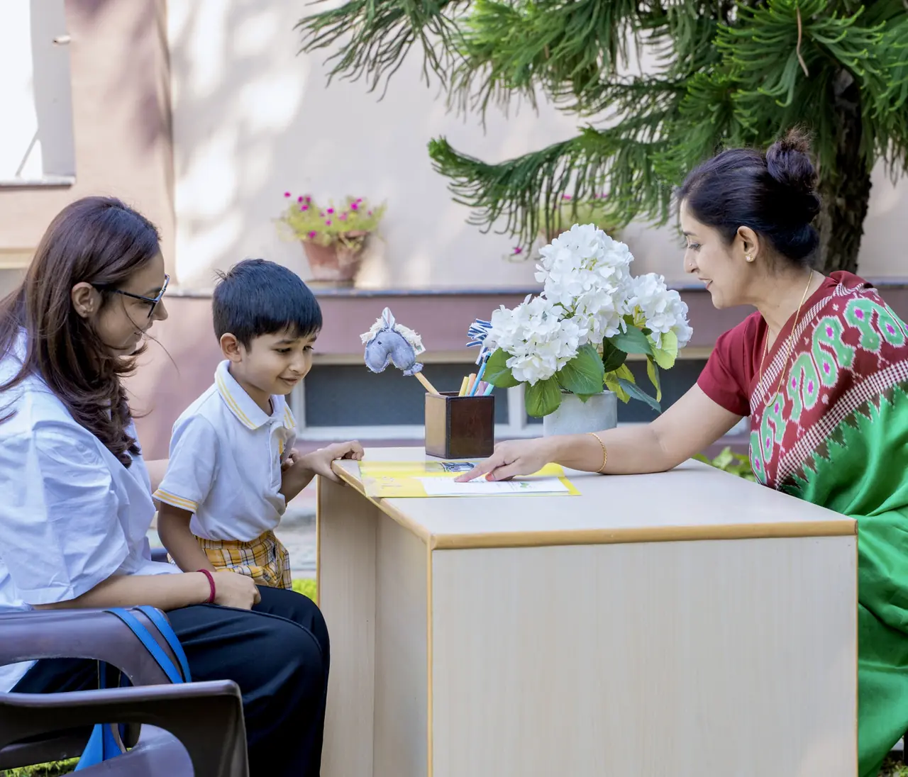 A teacher meeting a parent and child