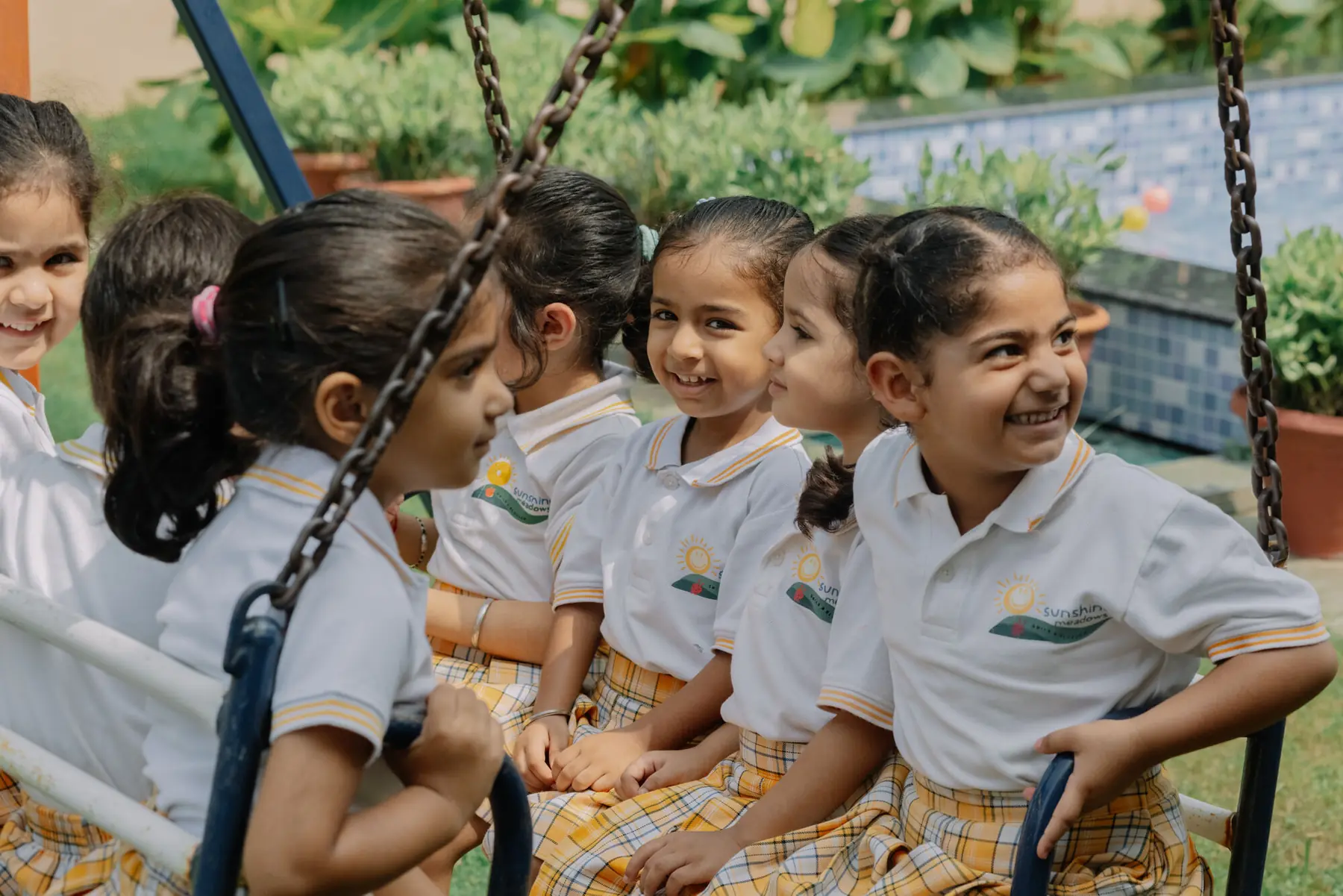 Children laughing together on the swings