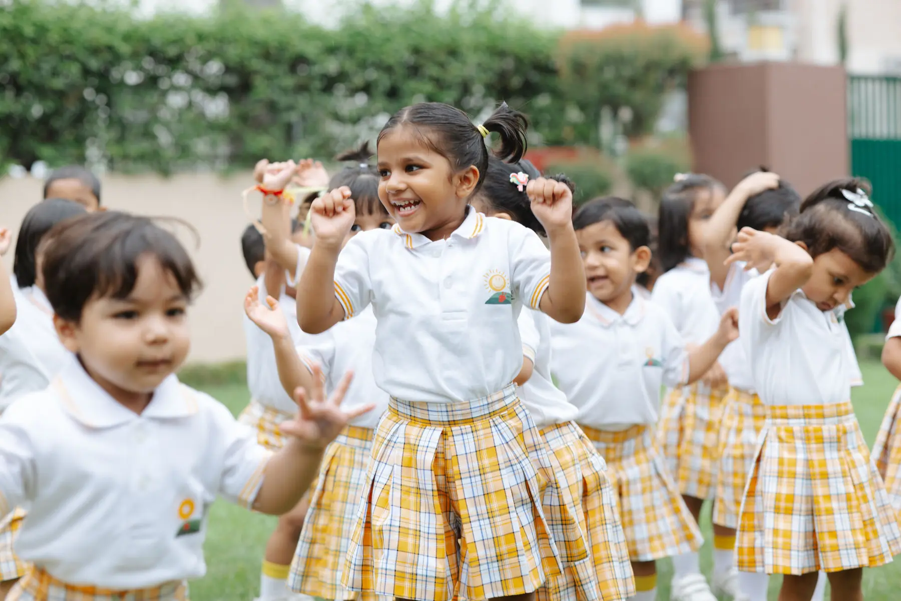 Children cheering on the lawn