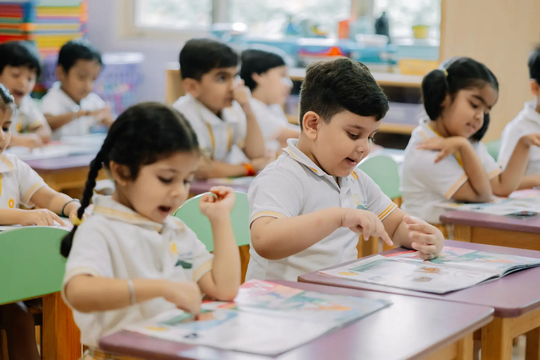Children reading at their desks in a classroom