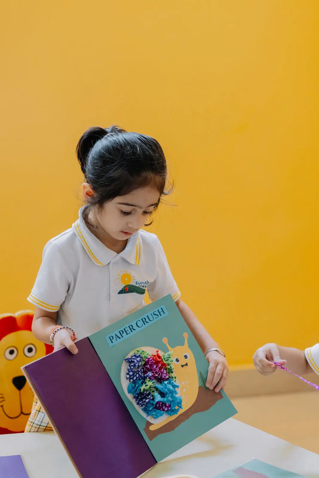 A child showing her paper craft